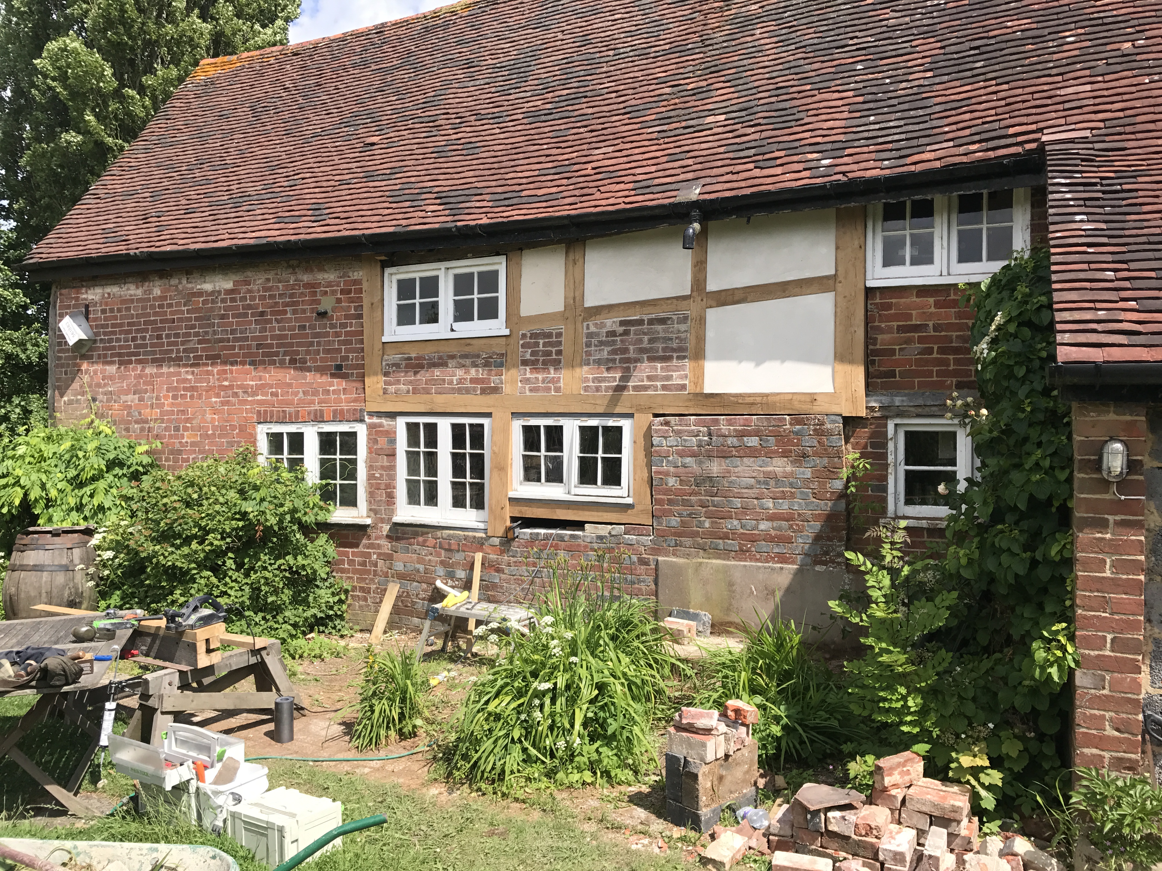 Decayed and collapsing wall frame rebuilt with new lime rendered panels