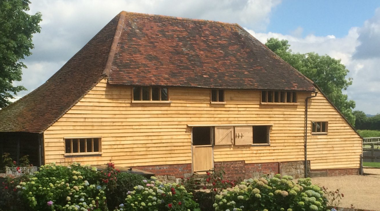 Oak weatherboarded Sussex barn